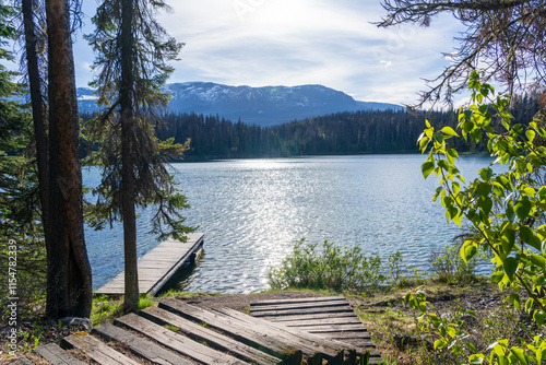 Fototapeta Naklejka Na Ścianę i Meble -  Wooden dock on the lake shore. Leach Lake, Jasper National Park. Alberta, Canada. Canadian Rockies summer landscape.