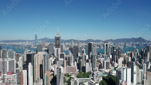 Drone footage showing cityscape buildings of Hong Kong by the South China Sea on a summer day
