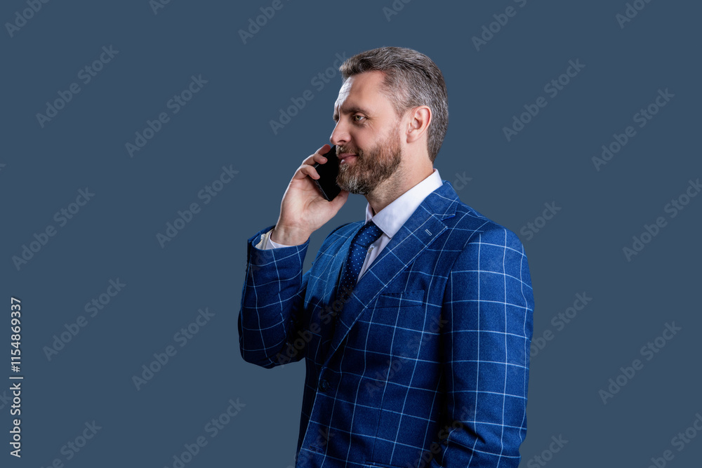 Businessman using phone. Man phone conversation in suit. Middle aged Hispanic businessman with phone. Business communication. Business man having phone call isolated on grey. Settlement terms Businessman using phone. Man phone conversation in suit. Middle aged Hispanic businessman with phone. Business communication. Business man having phone call isolated on grey. Settlement terms