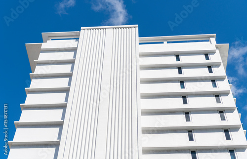 House exterior fragment. Modern apartment building. Apartment building with detail. View of white building. Residential building multistory architecture. Architectural exterior detail photo