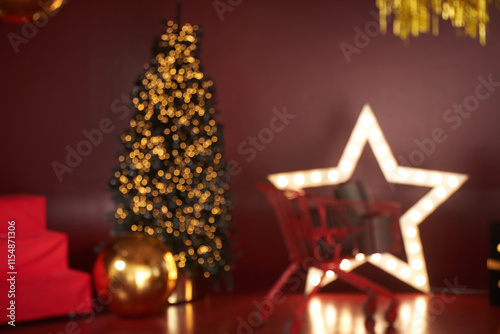 A blurry image in the New Year's decoration, the decor is done in red tones. Christmas tree in the interior in red and gold tones with space for copying. High quality photo photo