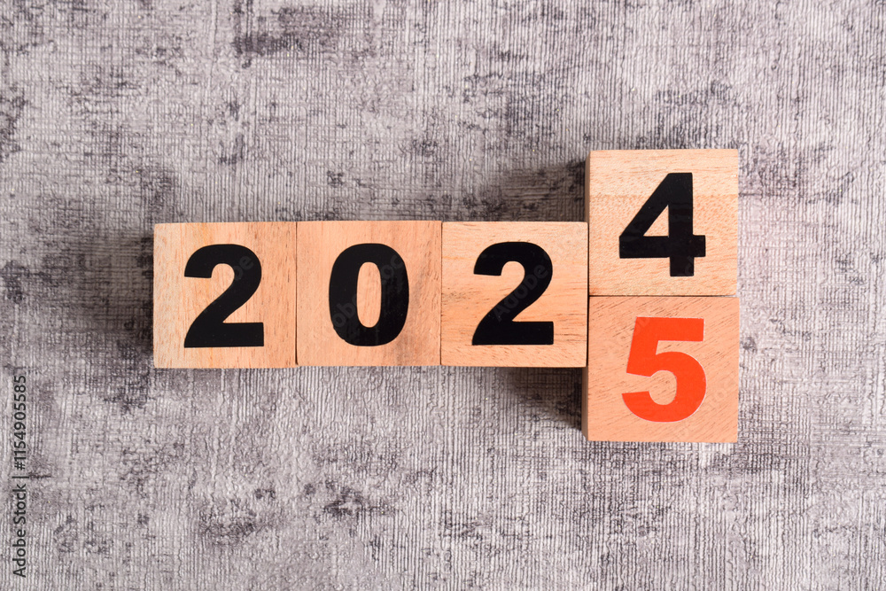 Fototapeta premium 2024 year change to 2025 year on wooden cubes. Annual concept 2024,2025. Plan, goal, trend