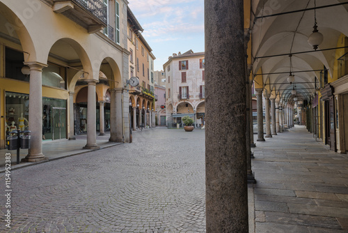 Fototapeta Naklejka Na Ścianę i Meble -  Novara city, Italy. Historic center with arcades and shops, pedestrian area with stone paving and porphyry cubes, street Fratelli Rosselli and square delle Erbe