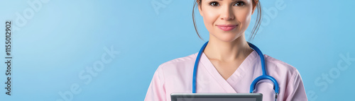 nurse smiling while holding tablet, wearing scrubs and st oscope photo