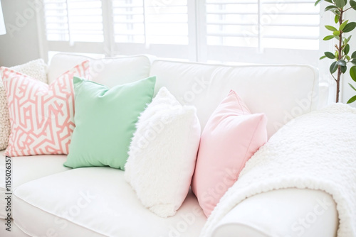 Living room white sofa pastel throw pillows textured blanket