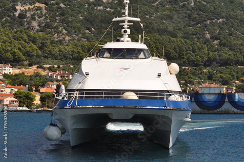 Cres, Croatia, July 28, 2024. The catamaran sailing into the city harbor. The catamaran with passengers sailing into the city harbor. Jadrolinija catamaran.