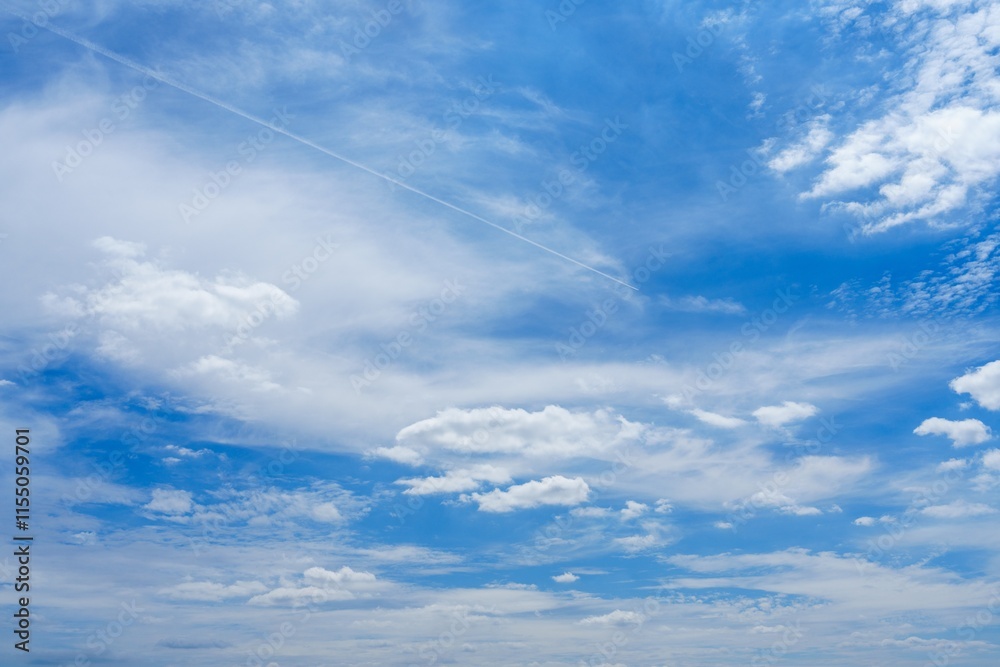 Obraz premium A stunning view showing a vast blue sky adorned with beautiful white fluffy clouds, ideal for nature enthusiasts and perfect as a serene background for various creative projects.
