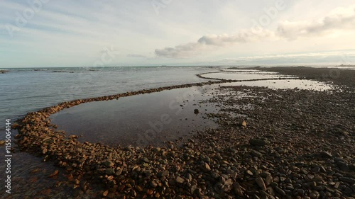 Ancient Rasperpunt fish traps along the L'Agulhas shoreline in the  Agulhas National Park. These tidal fish traps were probably built by pre-colonial Late Stone Age people. Western Cape. South Africa.
