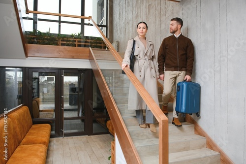 Couple on a business trip doing check-in at the hotel