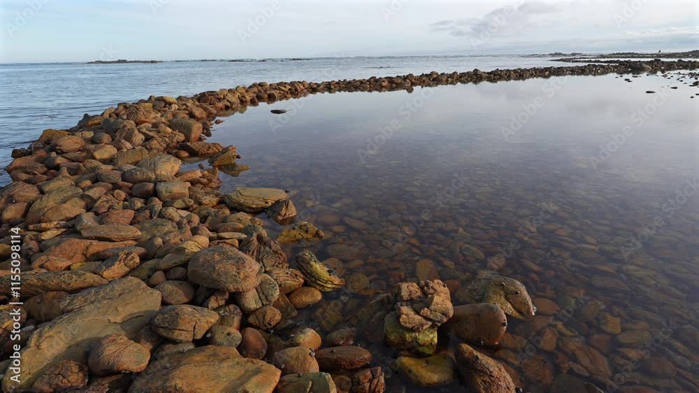 Ancient Rasperpunt fish traps along the L'Agulhas shoreline in the Agulhas National Park. These tidal fish traps were probably built by pre-colonial Late Stone Age people. Western Cape. South Africa. Ancient Rasperpunt fish traps along the L'Agulhas shoreline in the Agulhas National Park. These tidal fish traps were probably built by pre-colonial Late Stone Age people. Western Cape. South Africa.