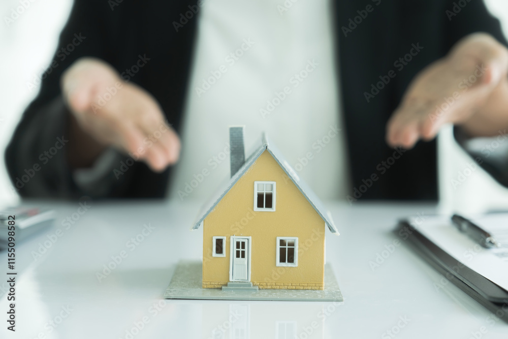 Real estate agent handing house model Real estate agent handing house model