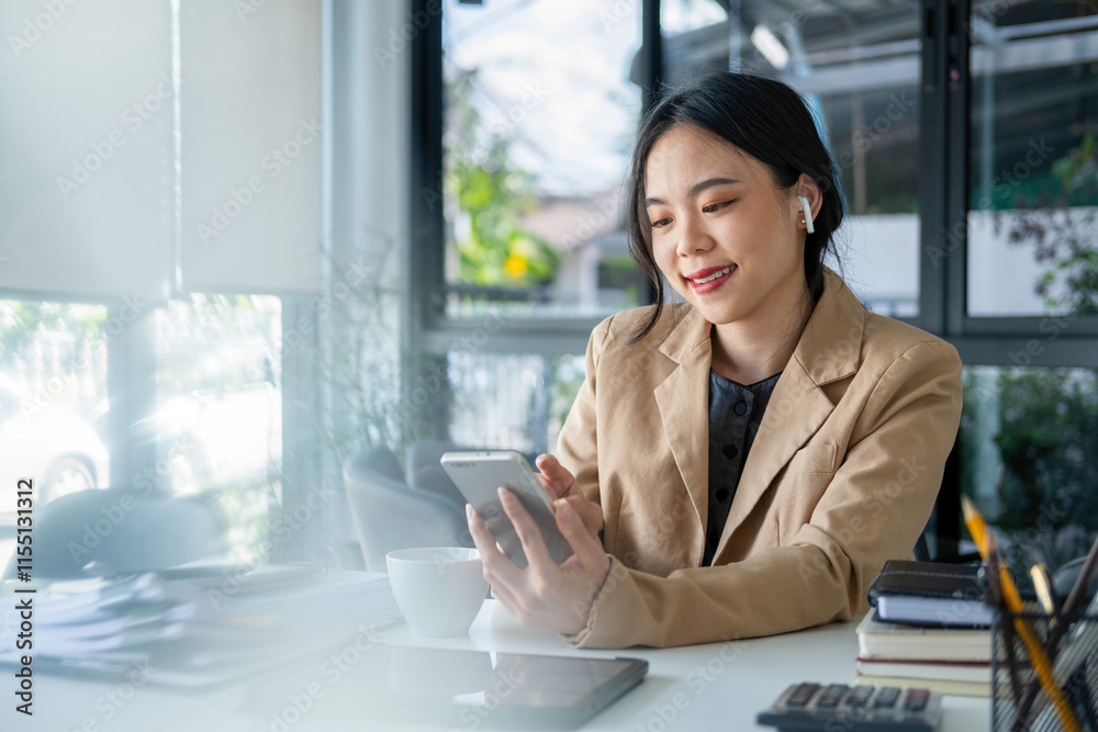 Businesswoman sitting at desk on couch in workplace or at home working on laptop and analyzing data on charts and graphs and writing on papers to make business plan and strategies for company, startup Businesswoman sitting at desk on couch in workplace or at home working on laptop and analyzing data on charts and graphs and writing on papers to make business plan and strategies for company, startup