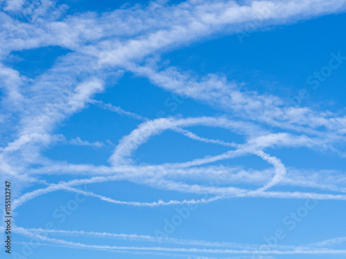 Airplane trace in the sky. Condensate tracks after the plane. Blue sky with chemtrails from air plane. The plane runs out of fuel to make an emergency landing. Military fighter jet training flight 
