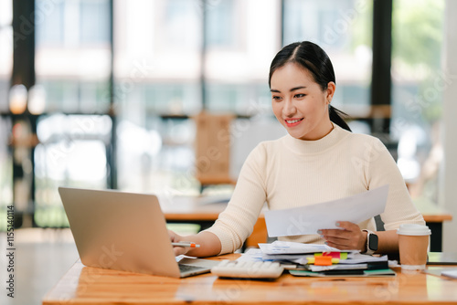 Wallpaper Mural Young Asian woman doing financial accounting and taxes for a company Organizing account analysis reports Investment information Financial and tax system concepts Torontodigital.ca