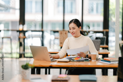 Young Asian woman doing financial accounting and taxes for a company Organizing account analysis reports Investment information Financial and tax system concepts