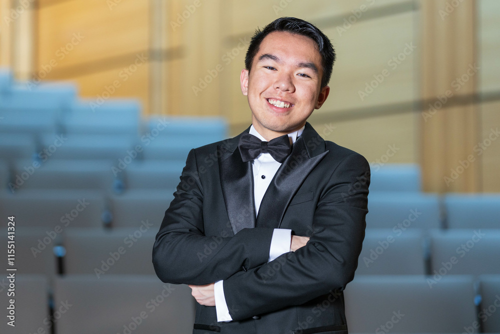 Smiling young man in a tuxedo arms crossed Smiling young man in a tuxedo arms crossed