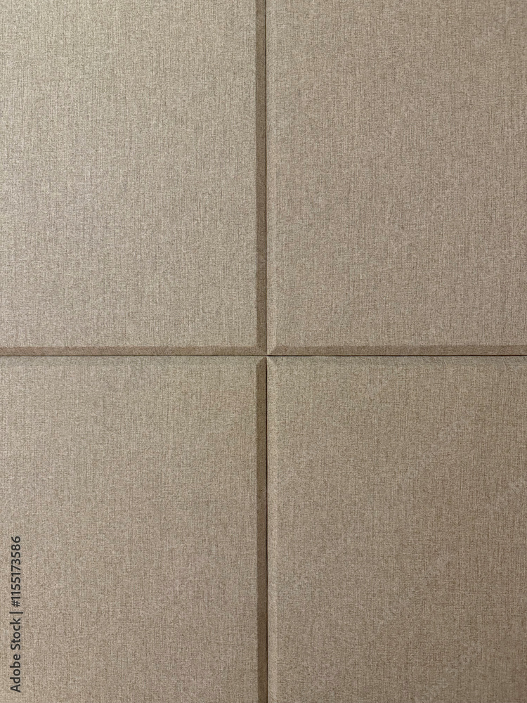 Fototapeta premium Brown beige and ivory color fabric, series of upholstered panel wall with beveled rectangular pattern. This functions as padded wall to sound insulation, or accoustic wall.