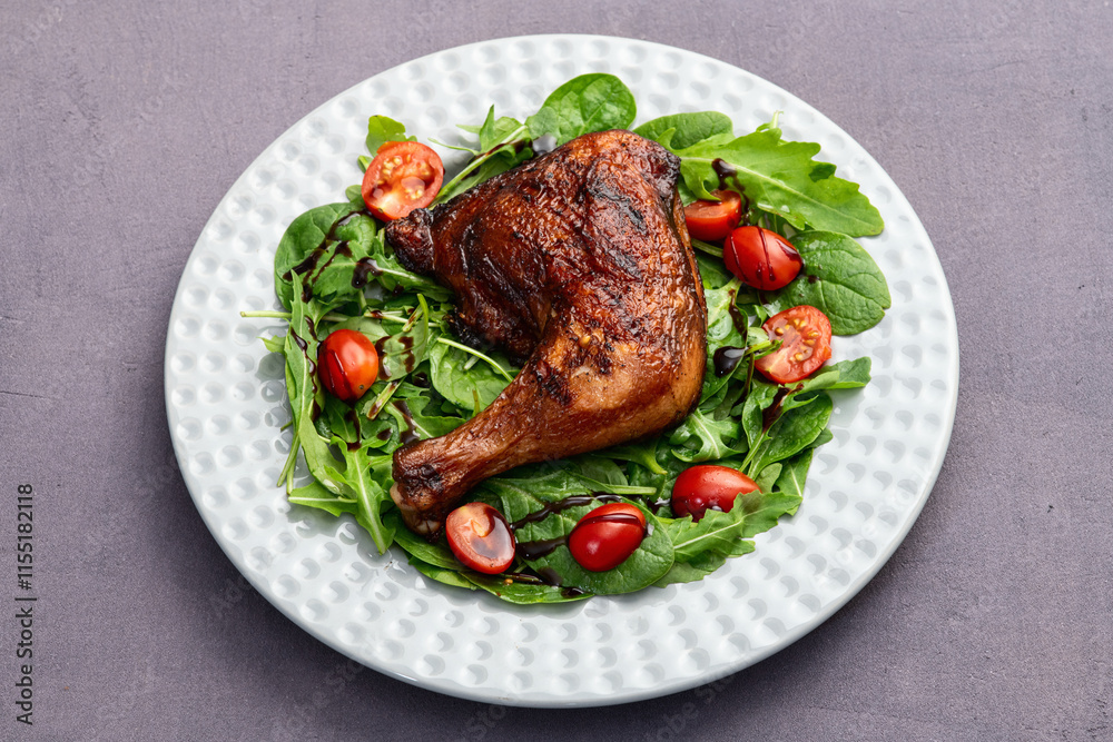 Grilled chicken legs with tomatoes and salad . Top view Grilled chicken legs with tomatoes and salad . Top view