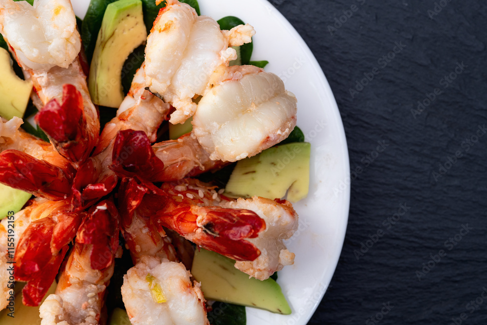 Salad with tiger shrimps , avocado and mango . Top view