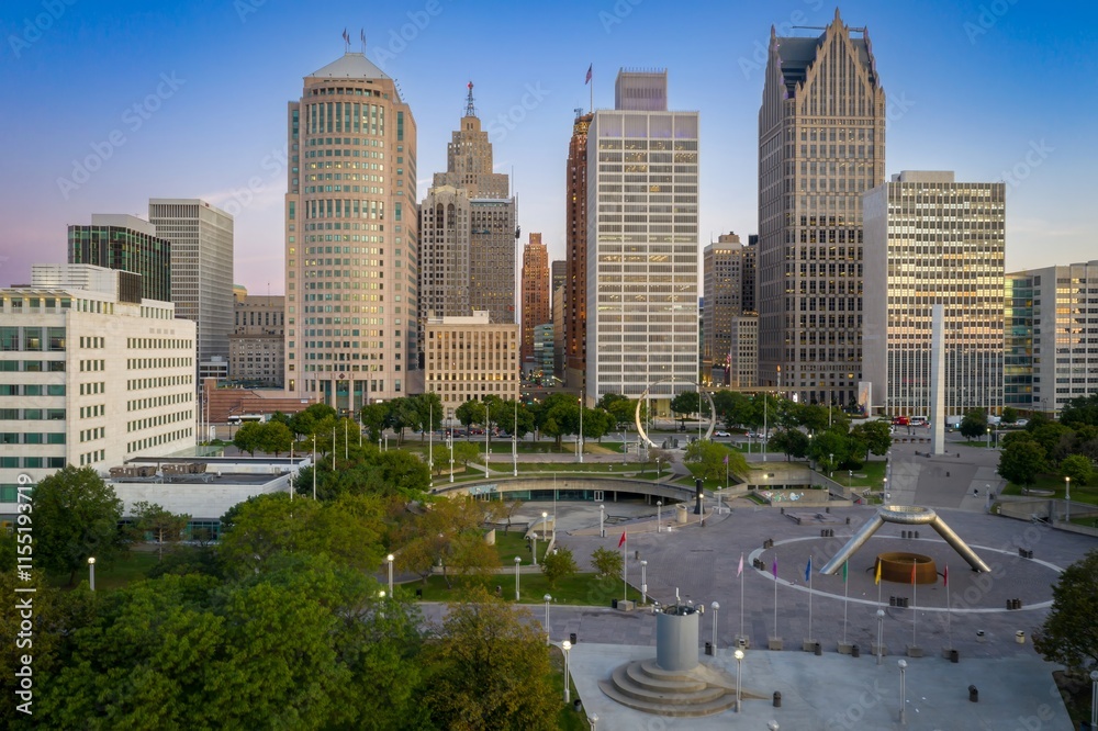 Detroit skyline at twilight, showcasing city's architectural grandeur. Urban park with modern monument. DOWNTOWN, DETROIT, MICHIGAN, UNITED STATES Detroit skyline at twilight, showcasing city's architectural grandeur. Urban park with modern monument. DOWNTOWN, DETROIT, MICHIGAN, UNITED STATES