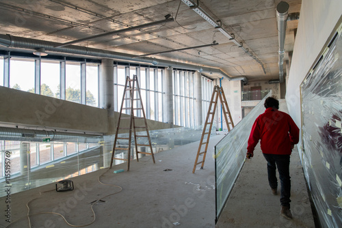 An engineer walks through the construction site, carefully inspecting the ongoing work to ensure quality control and progress in the project photo