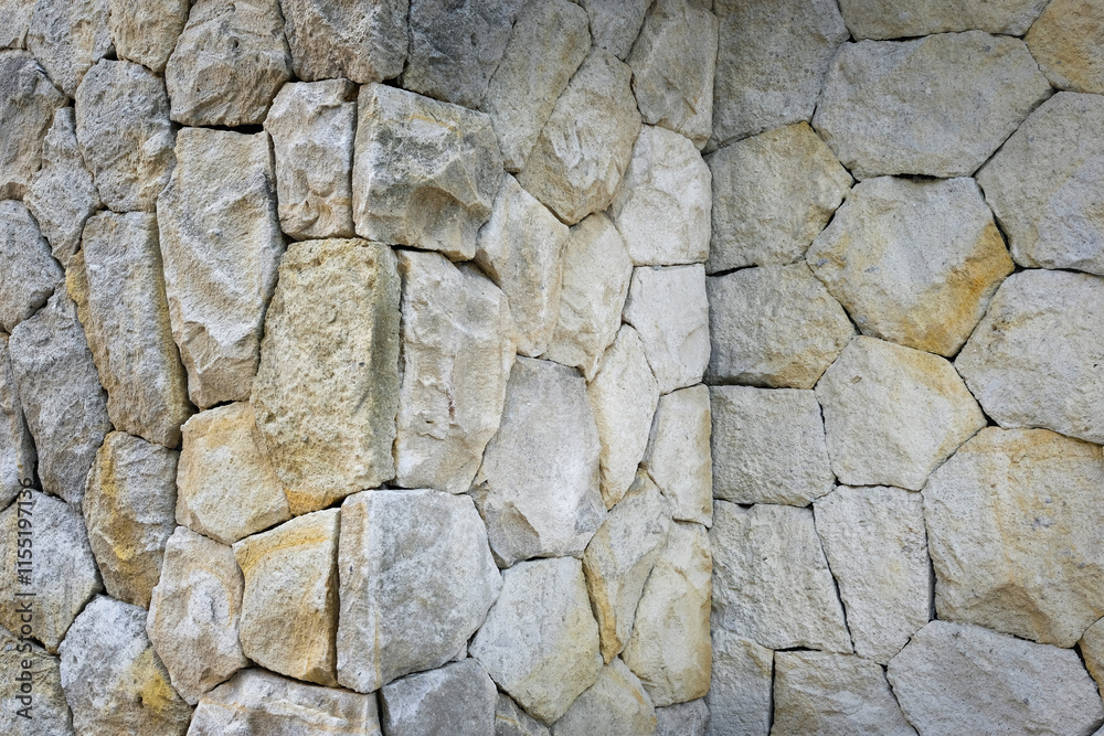 A collection of irregularly shaped stones in a wall. An ideal concept for a natural background A collection of irregularly shaped stones in a wall. An ideal concept for a natural background