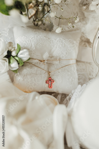 Billede på lærred Golden baptismal cross on a white lace pillow.