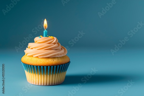 Delicious cupcake with candle on blue background with copy space for text, cupcake image for birthday card photo