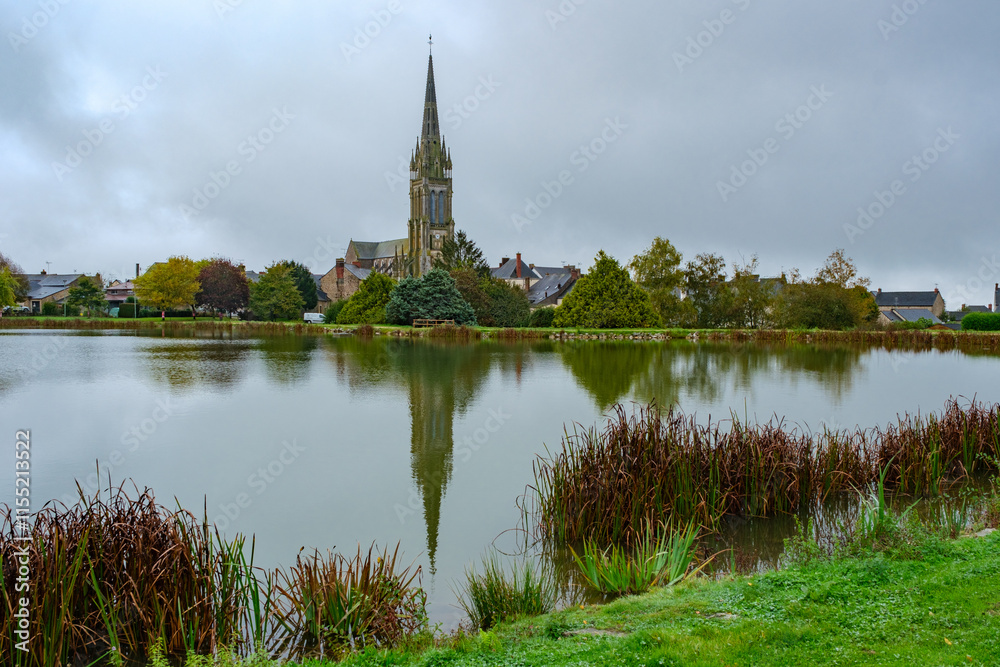 church of Saint-Martin-de-Vertou and lake in Le Pertre in France church of Saint-Martin-de-Vertou and lake in Le Pertre in France