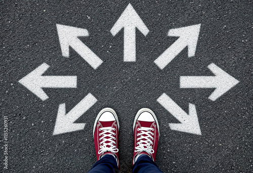 Sneakers shoes and arrows pointing in different directions on asphalt floor, life and studies choice for young people concept