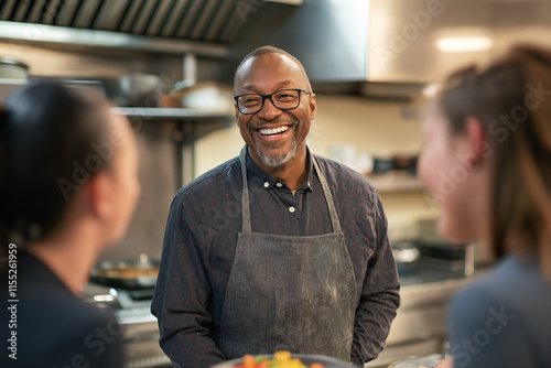 Happy cooking class instructor, smiling with students in a kitchen