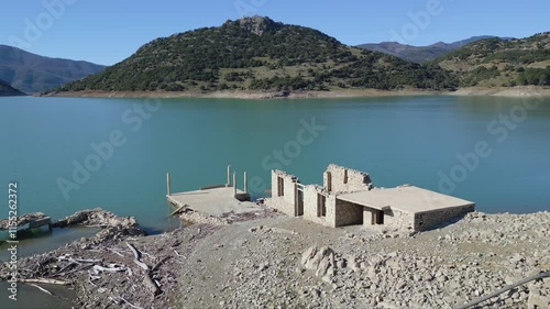 An orbital aerial view of the sunken houses submerged after the construction of the Evinos Dam photo