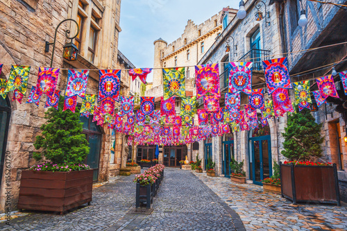 Fototapeta Naklejka Na Ścianę i Meble -  Decorated festive streets of the medieval stone city in French village in Ba Na Hills Park in Da Nang in Vietnam