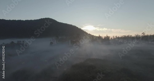 Sunlight behind the mountains with thick fog in the morning, a perfect time to camp