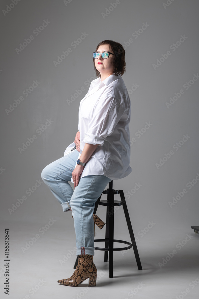 Fototapeta premium Portrait of a young beautiful plump girl in the studio.