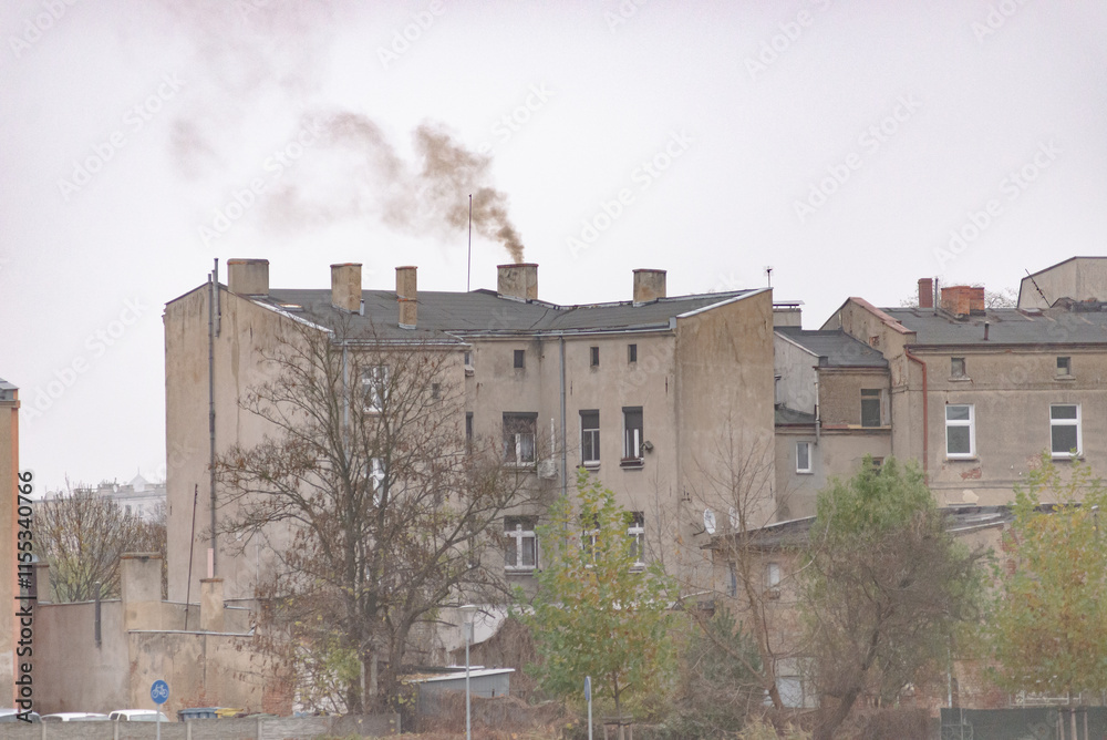 An old residential building realising a lot of black smoke to the atmosphere. Air pollution An old residential building realising a lot of black smoke to the atmosphere. Air pollution
