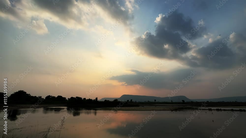 Cloudy day over the pond with reflection of sky on the water, Evening sky with dramatic clouds over the river. Cloudy day over the pond with reflection of sky on the water, Evening sky with dramatic clouds over the river.