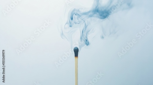 Smoke rising from extinguished matchstick with soft gradient background