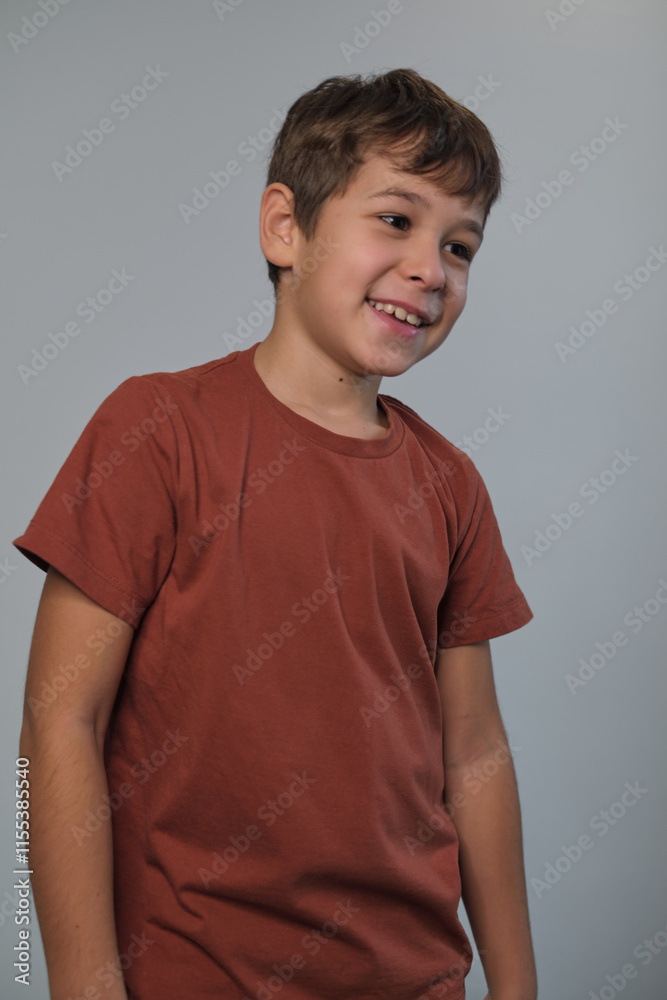 A joyful boy with a lively smile captures the essence of a happy and confident childhood moment.