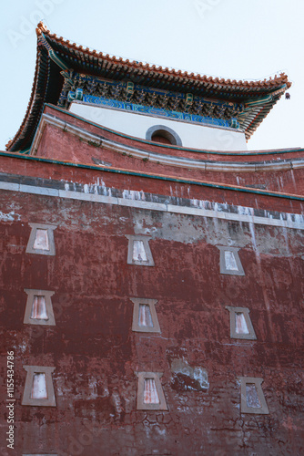 Traditional Chinese architecture with vibrant red pillars and intricate roof details photo