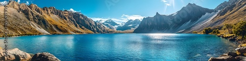 Panoramic view of the rugged mountains framing Lake Sarmiento. with the vibrant blue waters glowing under bright sunlight. in 4K resolution photo