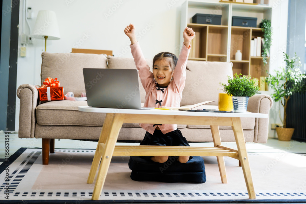 An Asian girl sits at home, studying with a laptop surrounded by books. Engaged in online learning, she stays focused and determined, embracing technology to achieve her academic goals An Asian girl sits at home, studying with a laptop surrounded by books. Engaged in online learning, she stays focused and determined, embracing technology to achieve her academic goals