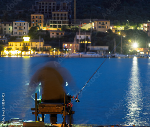 a man fishing in the gulf of la spezia at sunset