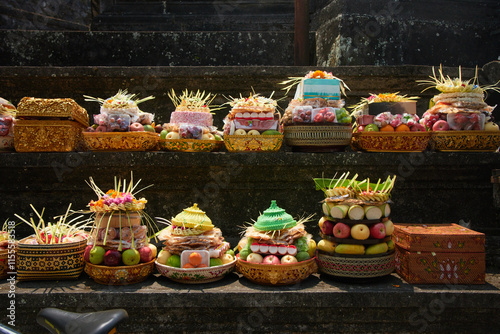 Traditional Balinese religious offerings in culorful hand-crafted boxes and baskets with food and decorations photo