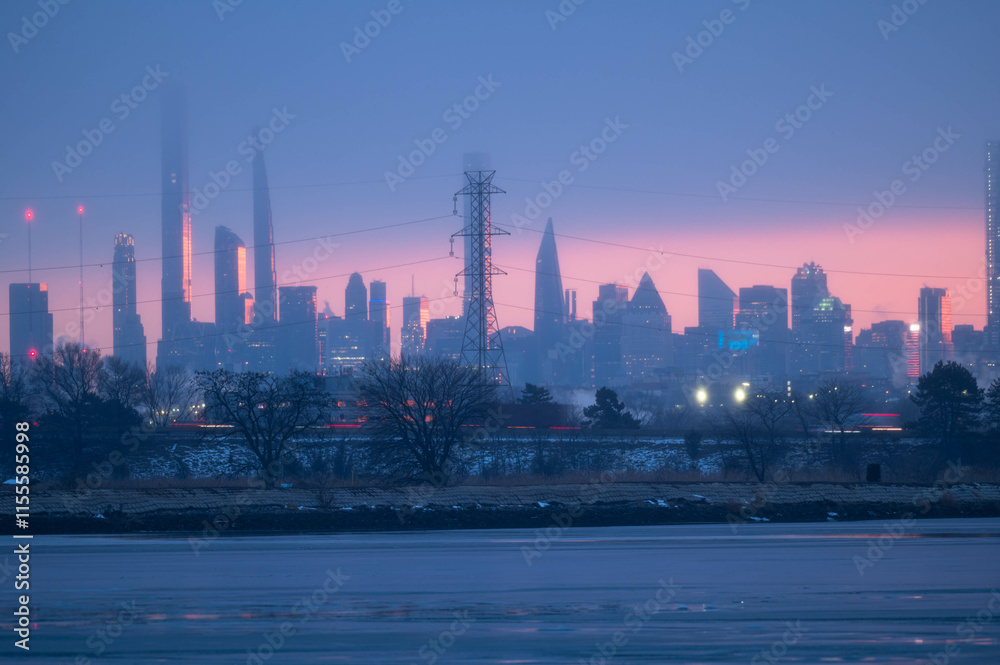 Fototapeta premium Stunning manhatta NYC skyline during sunrise winter season, far away skyline taken from New Jersy side, copy space travel world famous destination