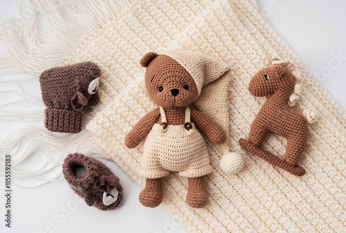 Variety of knitted toys. Bear, horse and baby booties. Handmade soft toys.