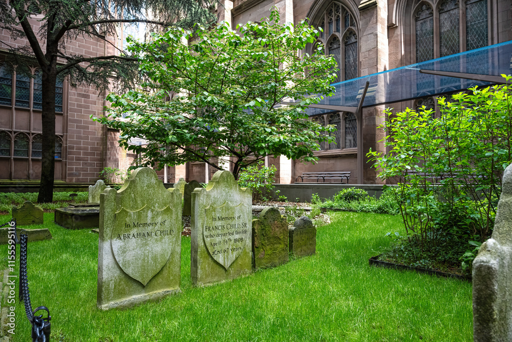 Old gravestones with lush green grass at Trinity Church in New York City Old gravestones with lush green grass at Trinity Church in New York City