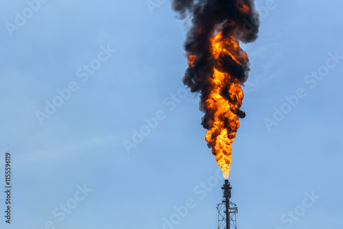Oil Refinery Factory Plant With Flare Gas Emission. Refinery chimney with fire. Flames from the chimney of gas station. fume of fire on flare stack to burning heat gas.