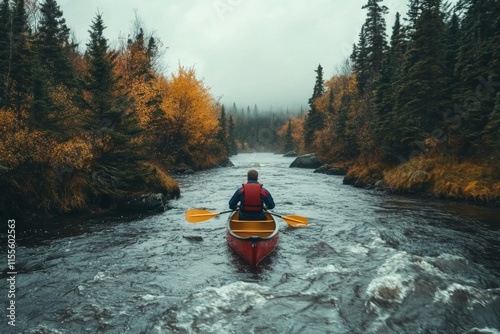Canoeing through a tranquil river surrounded by autumn foliage and misty moun...