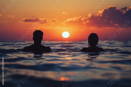 Friends enjoy sunset while swimming in calm ocean waters during warm evening ...